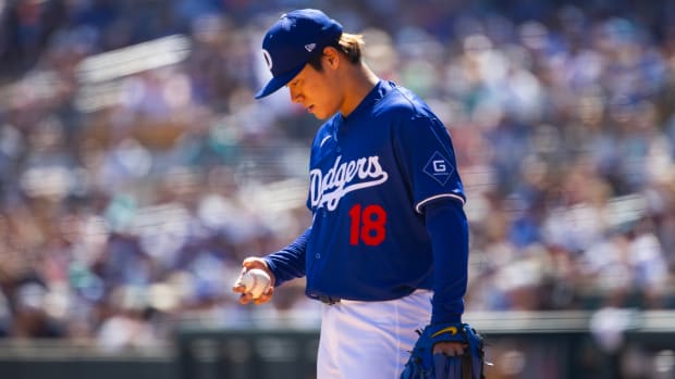 Mar 13, 2024; Phoenix, Arizona, USA; Los Angeles Dodgers pitcher Yoshinobu Yamamoto reacts against the Seattle Mariners during a spring training game at Camelback Ranch-Glendale.